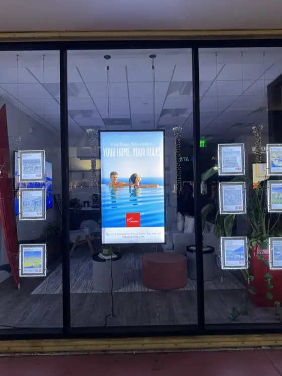 CrownTV window digital signage at The Agency Real Estate