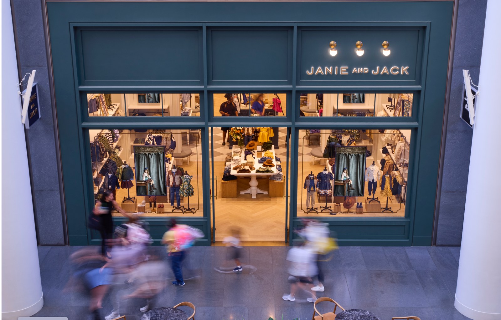 Janie and Jack mall storefront with synchronized Samsung OM55B 3,500-nit window displays — multi-location digital signage rollout managed by CrownTV.