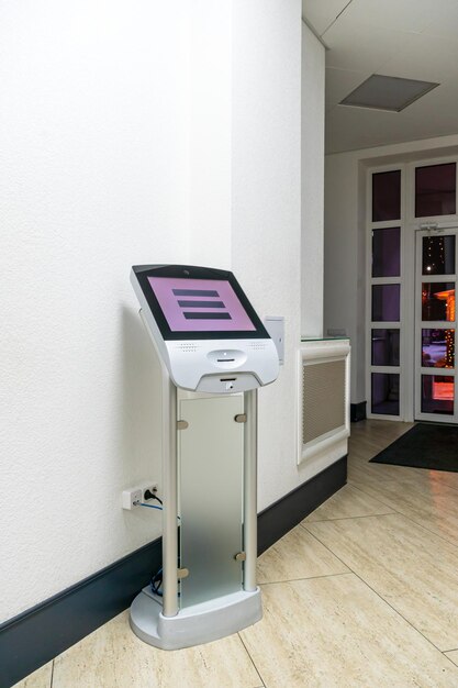 A modern touch screen terminal for customer service an electronic queue in the service sector Using a selfservice kiosk or a terminal with a screen A quick way to order food and buy tickets