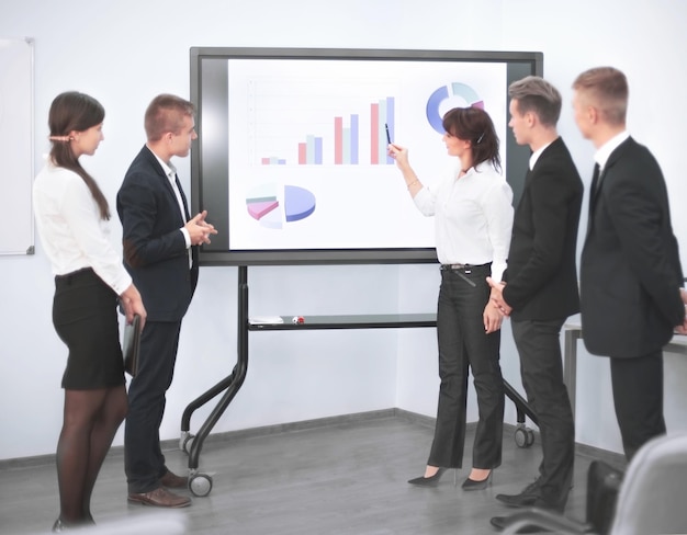 Business woman giving presentation to colleagues during meeting