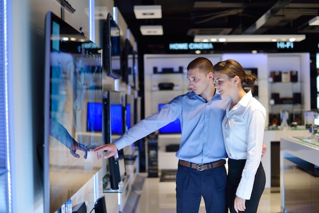 Young couple in consumer electronics store